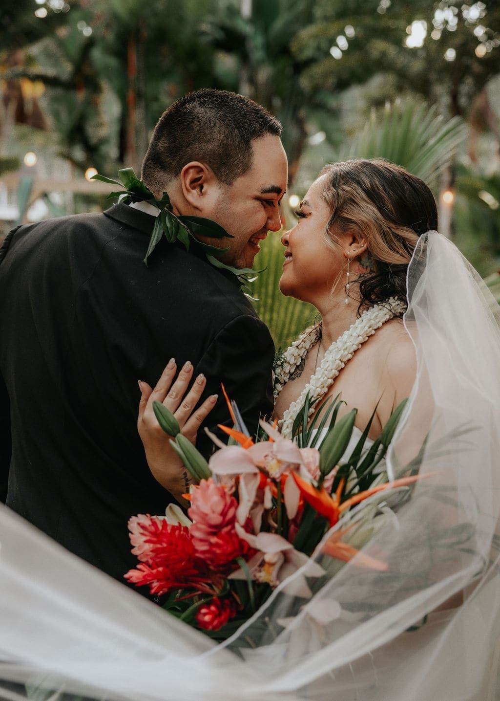 Newlyweds nose to nose with a tropical bouquet — Oahu wedding planned by Lucky In Love